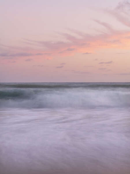 pastels filled the sky and waves crashed against the shore