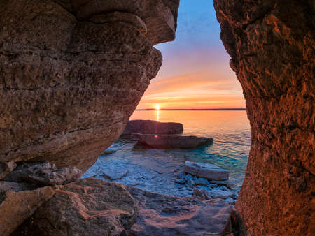 Sunset from crevice on shore