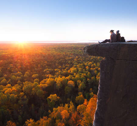 Two People on Peak Above Forest